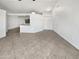 Spacious living room with tiled flooring and access to an adjoining kitchen space at 5654 W Villa Theresa Dr, Glendale, AZ 85308