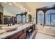 Primary bathroom features a tub, walk in shower, double sinks, and shuttered windows at 6925 W Tonto Dr, Glendale, AZ 85308
