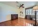 Bright bedroom features hardwood floors, a ceiling fan and palm tree artwork at 6925 W Tonto Dr, Glendale, AZ 85308