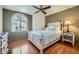 A bedroom with wooden floors features a bed and a window with natural light at 6925 W Tonto Dr, Glendale, AZ 85308