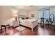 Bright bedroom with hardwood floors and a cushioned bench and chair near a window at 6925 W Tonto Dr, Glendale, AZ 85308
