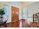 Bright foyer featuring hardwood floors, a wooden front door, and views into other rooms at 6925 W Tonto Dr, Glendale, AZ 85308