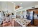 Modern kitchen with granite island, stainless steel refrigerator, and an open view to the dining area at 6925 W Tonto Dr, Glendale, AZ 85308
