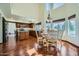 Bright kitchen with wood cabinets, an island, hardwood floors, and an adjacent dining area at 6925 W Tonto Dr, Glendale, AZ 85308