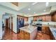 Well-equipped kitchen with stainless steel appliances, a central island, and wooden cabinetry at 6925 W Tonto Dr, Glendale, AZ 85308