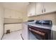 Laundry room with modern washer and dryer and storage cabinets above at 6925 W Tonto Dr, Glendale, AZ 85308