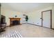Comfortable living area with a fireplace, neutral walls, and a door leading outside at 6925 W Tonto Dr, Glendale, AZ 85308