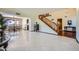 Open-concept living room with tile floors, staircase, and adjacent dining area for easy entertaining at 6925 W Tonto Dr, Glendale, AZ 85308