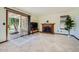 Cozy living room featuring a fireplace, sliding glass doors to the patio, and tile flooring at 6925 W Tonto Dr, Glendale, AZ 85308