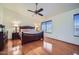 Spacious bedroom showcasing wood floors, a ceiling fan, and a large window at 6925 W Tonto Dr, Glendale, AZ 85308