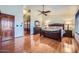 Primary bedroom features wood floors, a ceiling fan, a dresser, and a walk-in closet at 6925 W Tonto Dr, Glendale, AZ 85308