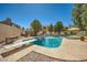 A backyard pool features a diving board, nearby bench, and a surrounding block fence at 6925 W Tonto Dr, Glendale, AZ 85308