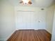 Bedroom features wood flooring, a closet with white doors and white walls at 6961 E Osborn Rd # B, Scottsdale, AZ 85251