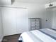 Bedroom view showcasing a bed with a grey dresser, and a closet with white doors at 6961 E Osborn Rd # B, Scottsdale, AZ 85251