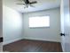 Bright bedroom featuring wood flooring, large window with blinds, and neutral paint at 6961 E Osborn Rd # B, Scottsdale, AZ 85251