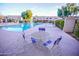 Close up view of the community pool with tables and chairs on the patio at 6961 E Osborn Rd # B, Scottsdale, AZ 85251