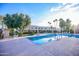 Community pool view with buildings in the background on a bright sunny day at 6961 E Osborn Rd # B, Scottsdale, AZ 85251