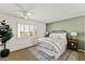 Bright bedroom with shutters, ceiling fan, and calming green accent wall at 7930 E Camelback Rd # 409, Scottsdale, AZ 85251