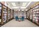 Library featuring floor to ceiling bookshelves filled with books, with comfy chairs and bright overhead lighting at 7930 E Camelback Rd # 409, Scottsdale, AZ 85251