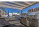 Outdoor kitchen area featuring stainless steel grills and a countertop, with a pool in the background at 7930 E Camelback Rd # 409, Scottsdale, AZ 85251