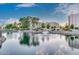 Scenic pond with fountains reflecting the residential buildings under a bright sky at 7930 E Camelback Rd # 409, Scottsdale, AZ 85251