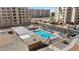 Aerial view of a community pool with lounge chairs and mature trees at 7930 E Camelback Rd # 409, Scottsdale, AZ 85251