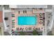 Overhead view of a refreshing pool with lounge chairs, tables, and umbrellas on a sunny day at 7930 E Camelback Rd # 409, Scottsdale, AZ 85251