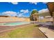Spacious backyard with in-ground swimming pool, grass, gravel and covered patio at 8014 W Mescal St, Peoria, AZ 85345