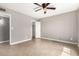 Serene bedroom with tile flooring, ceiling fan, closet, and neutral walls at 8014 W Mescal St, Peoria, AZ 85345