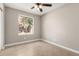 Bedroom features tiled floor, neutral paint and a window overlooking the backyard at 8014 W Mescal St, Peoria, AZ 85345