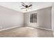Bright bedroom features neutral paint, a ceiling fan, and tiled floors at 8014 W Mescal St, Peoria, AZ 85345