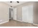 Bedroom with tiled flooring, closet and view to an adjacent room at 8014 W Mescal St, Peoria, AZ 85345