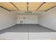 Spacious and clean garage with ample storage, utility sink, and freshly painted floor provides secure parking and workspace at 8014 W Mescal St, Peoria, AZ 85345