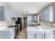 Well-lit kitchen featuring updated appliances and ample cabinet space at 8014 W Mescal St, Peoria, AZ 85345