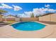 Clear blue pool is highlighted against a sunny sky, surrounded by a well-maintained concrete deck and privacy fencing at 8014 W Mescal St, Peoria, AZ 85345