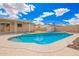 Inviting pool is showcased under a bright sky, complemented by a well-maintained pool deck, and landscaping at 8014 W Mescal St, Peoria, AZ 85345