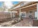 Spacious backyard with covered patio featuring brick pavers, a ceiling fan, and access to a grassy area at 8226 N 32Nd Dr, Phoenix, AZ 85051