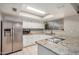 Well-lit kitchen featuring white cabinets, stainless steel appliances, and granite countertops at 8226 N 32Nd Dr, Phoenix, AZ 85051