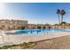 Community pool with blue water, bordered by a fence, landscaping, and lounge seating at 8226 N 32Nd Dr, Phoenix, AZ 85051