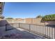 Gravel-covered backyard area showcasing a decorative wall, various plants, black railing and shade at 8320 E Nido Ave, Mesa, AZ 85209