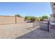 Low maintenance gravel backyard with block wall and black railing around sunroom addition at 8320 E Nido Ave, Mesa, AZ 85209