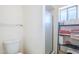 Clean and functional bathroom with shower, toilet, and storage shelving at 8320 E Nido Ave, Mesa, AZ 85209