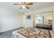 Spacious bedroom with carpet flooring, ceiling fan, and a mirrored closet providing ample storage space at 8320 E Nido Ave, Mesa, AZ 85209