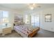 Bright bedroom featuring a ceiling fan and sliding doors to a screened-in patio at 8320 E Nido Ave, Mesa, AZ 85209