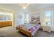 Cozy bedroom featuring southwestern-style decor and ensuite bathroom with ample natural light at 8320 E Nido Ave, Mesa, AZ 85209