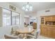 Cozy dining area with a round table, four chairs, and a large window at 8320 E Nido Ave, Mesa, AZ 85209