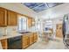 Charming kitchen with wood cabinets, black appliances, and an open view to the dining area at 8320 E Nido Ave, Mesa, AZ 85209