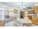 Eat-in kitchen featuring oak cabinets, black appliances, and tiled flooring at 8320 E Nido Ave, Mesa, AZ 85209