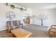 Spacious living room featuring cozy furniture, carpet flooring, and decorative wall art at 8320 E Nido Ave, Mesa, AZ 85209