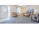 Bright living room with neutral carpeting, comfortable seating, and a decorative window at 8320 E Nido Ave, Mesa, AZ 85209